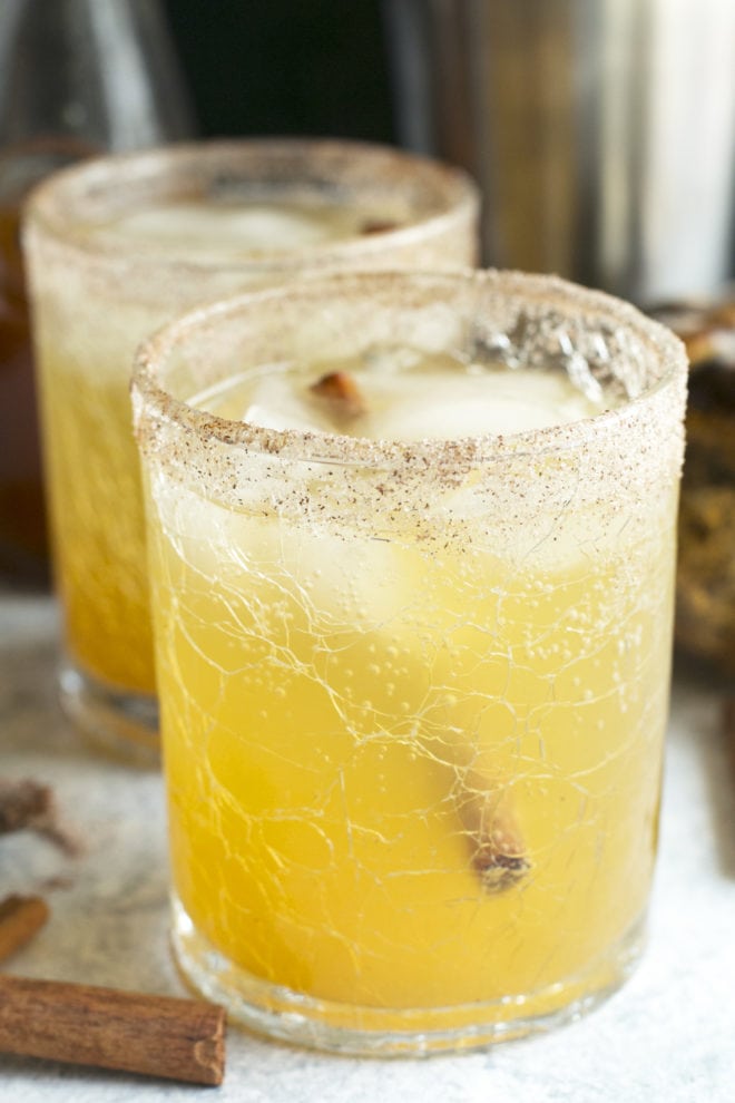 Side image of pumpkin bourbon smash cocktail in glasses