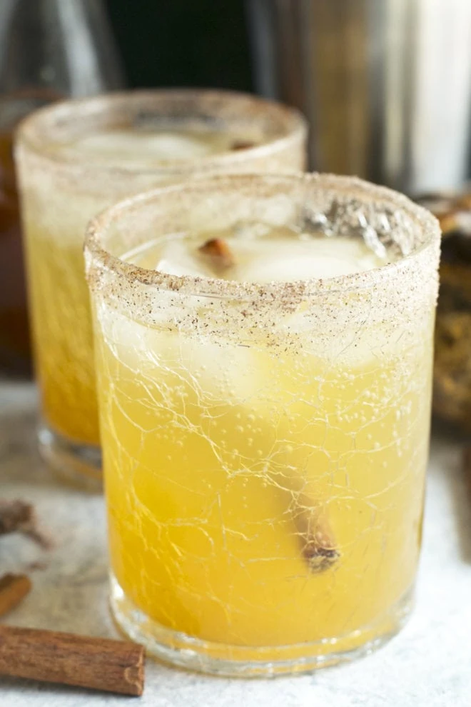 Side image of pumpkin bourbon smash cocktail in glasses