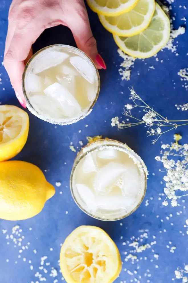 Overhead image of lemon cocktails with hand