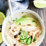 Bowl of Slow cooker creamy white chicken chili with spoon in it