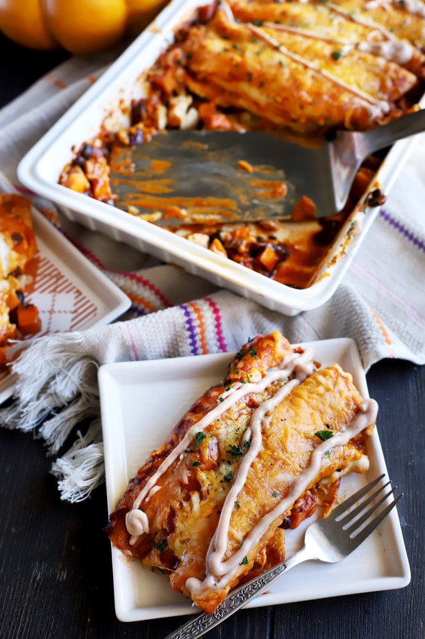 Freshly baked enchiladas garnished with cilantro and crema