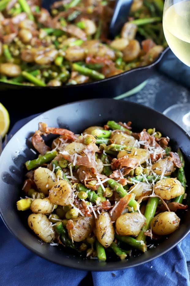 bowl of brown butter gnocchi with asparagus and peas