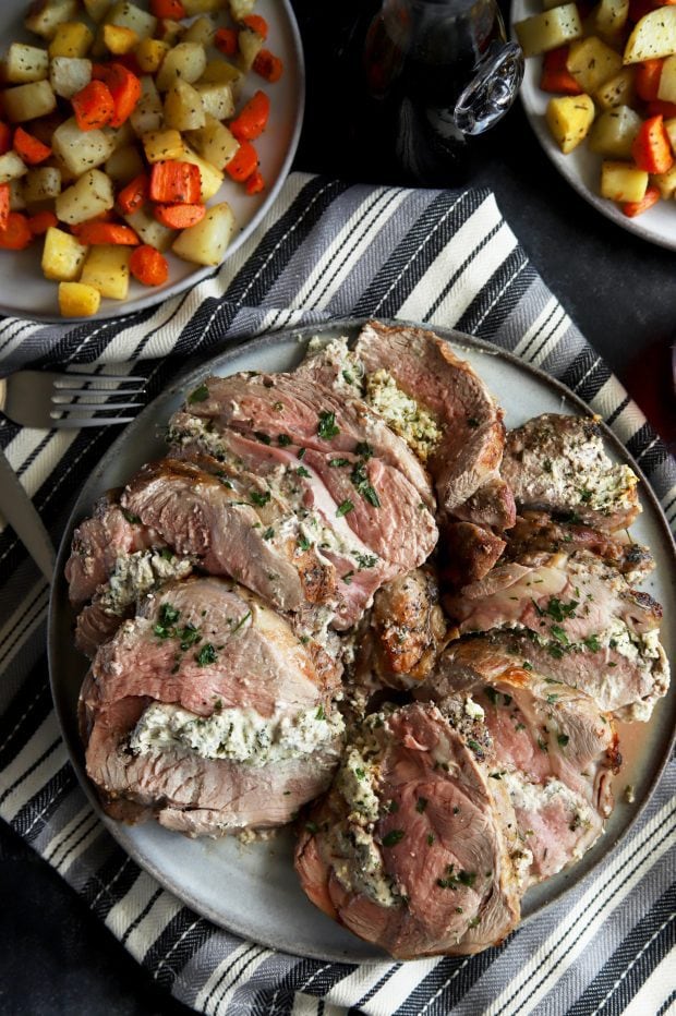 Sliced stuffed leg of lamb with vegetables