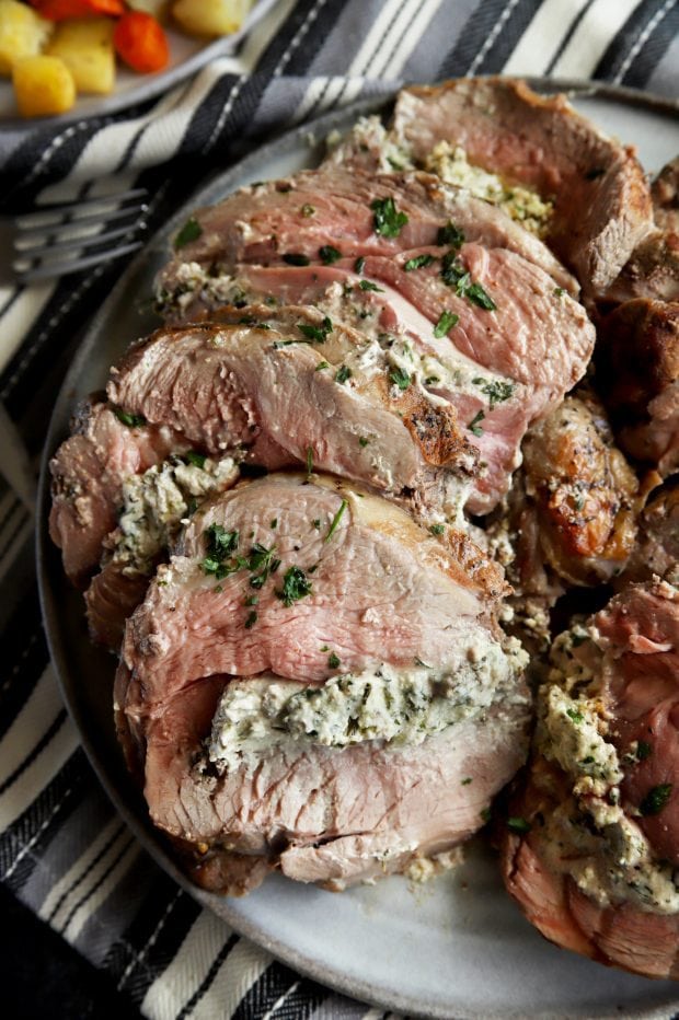 Stuffed leg of lamb on a platter