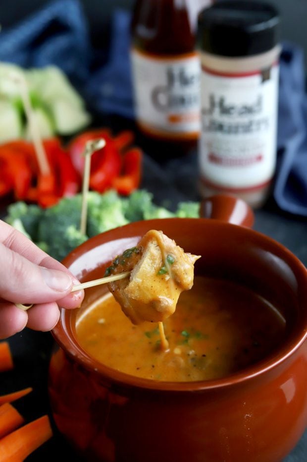 Bread dipping into short rib BBQ fondue