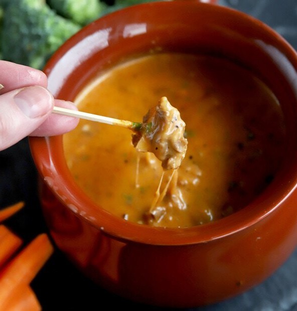 Apple dipping into cheese BBQ fondue