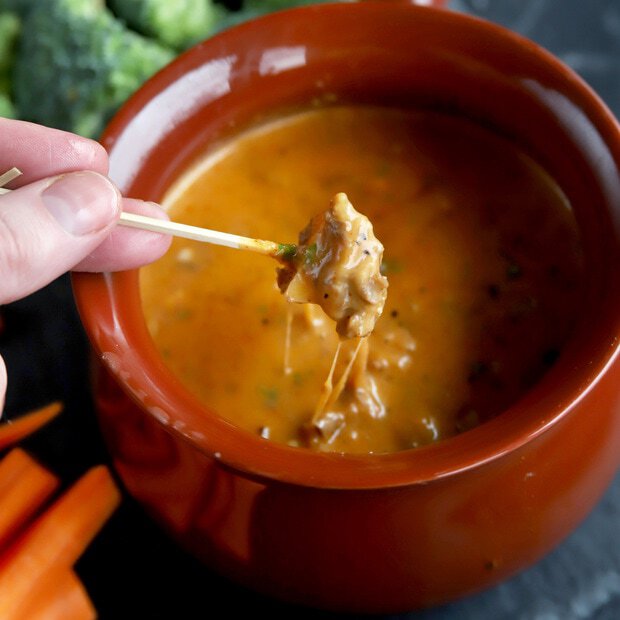 Apple dipping into cheese BBQ fondue