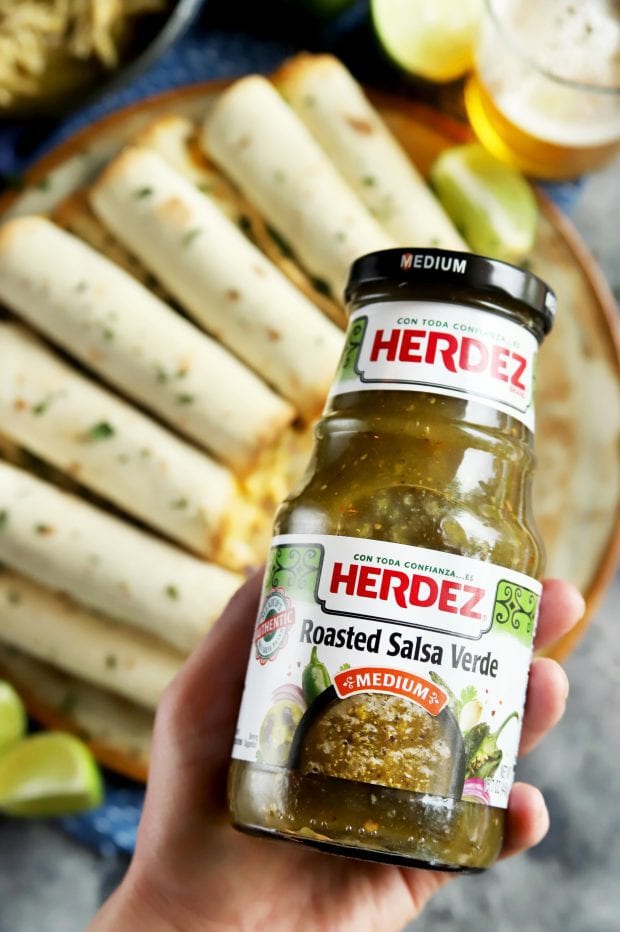 Holding a jar of salsa verde from HERDEZ