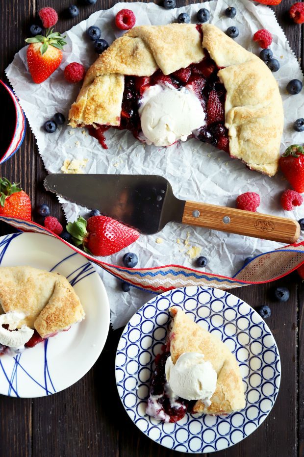 Sliced up berry galette with ice cream