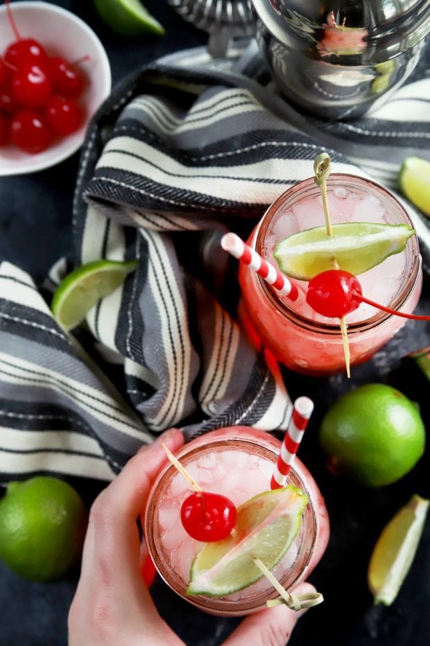 Overhead shot of cherry limeade cocktails in mason jars