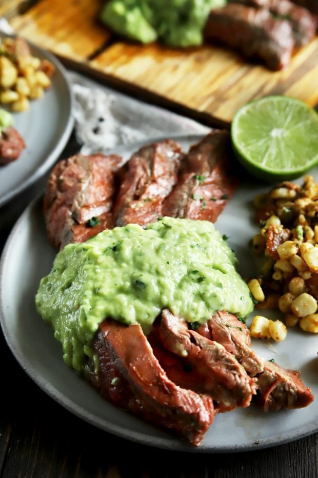 Pieces of flank steak with salsa and corn salad