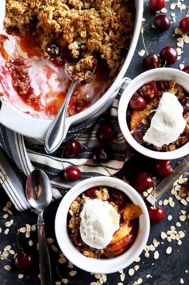 Bowls of summer fruit crumble and ice cream