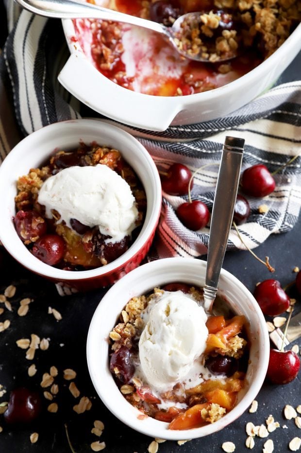 Small bowls of fruit crumble with ice cream