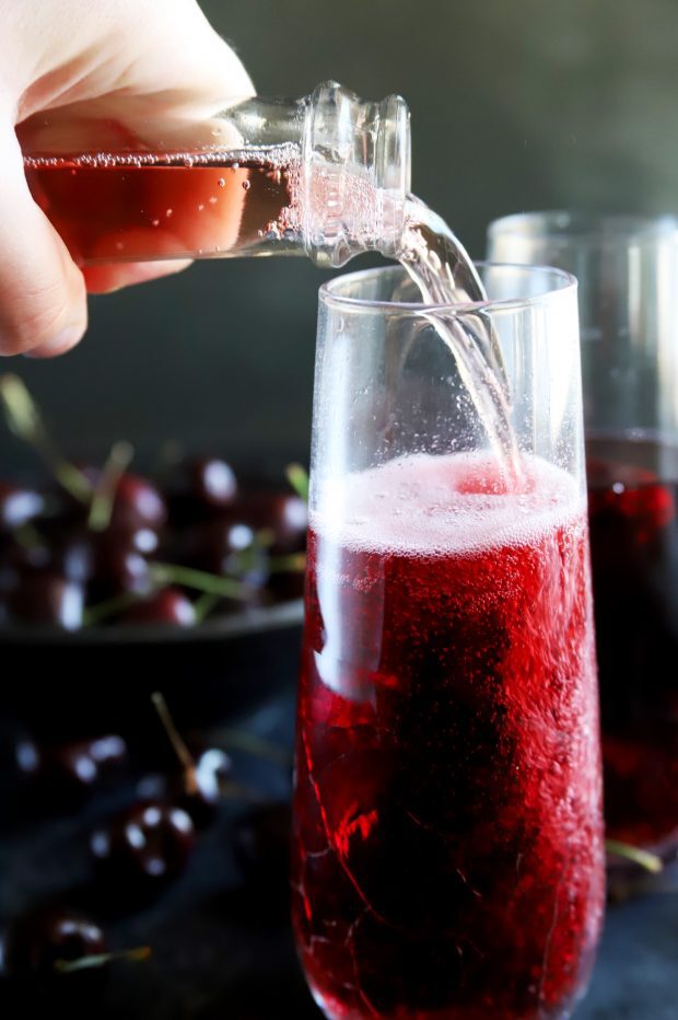 Pouring in sparkling rose into a champagne flute