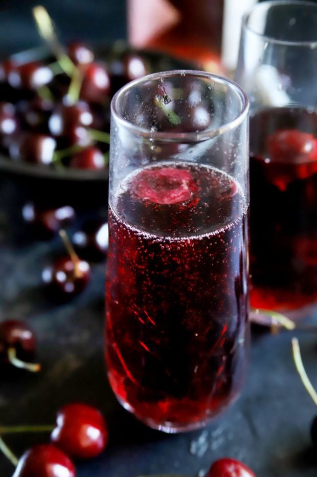 Cherry red mimosa with fresh cherries and rose