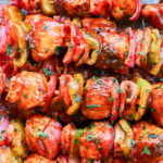 Skewers of chicken, bacon, onion, and bell pepper with bbq sauce