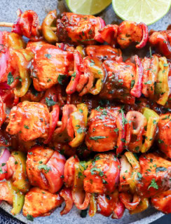 Skewers of chicken, bacon, onion, and bell pepper with bbq sauce