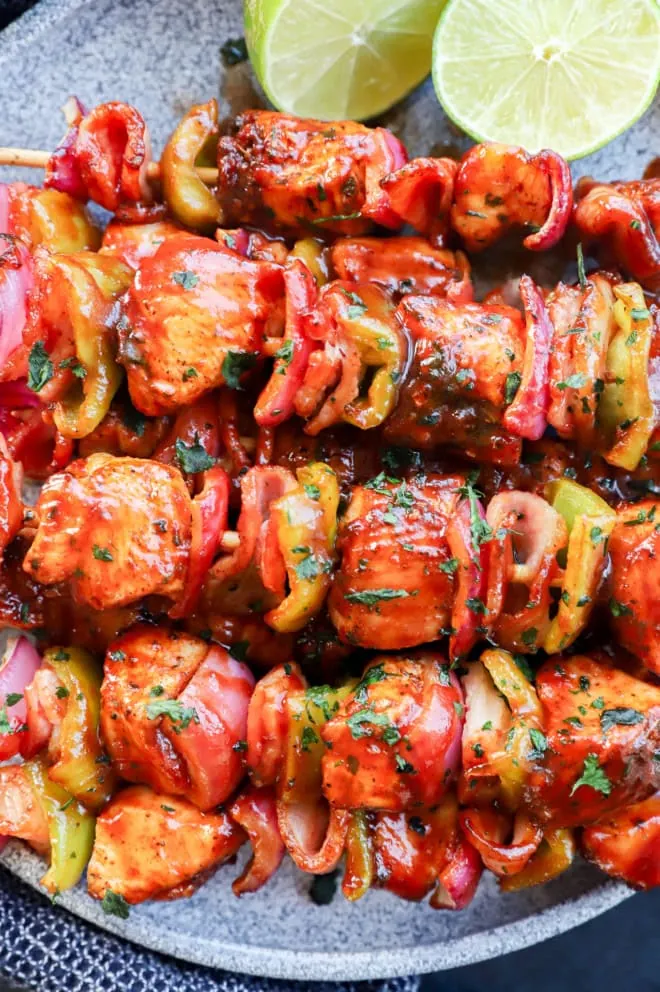 Skewers of chicken, bacon, onion, and bell pepper with bbq sauce