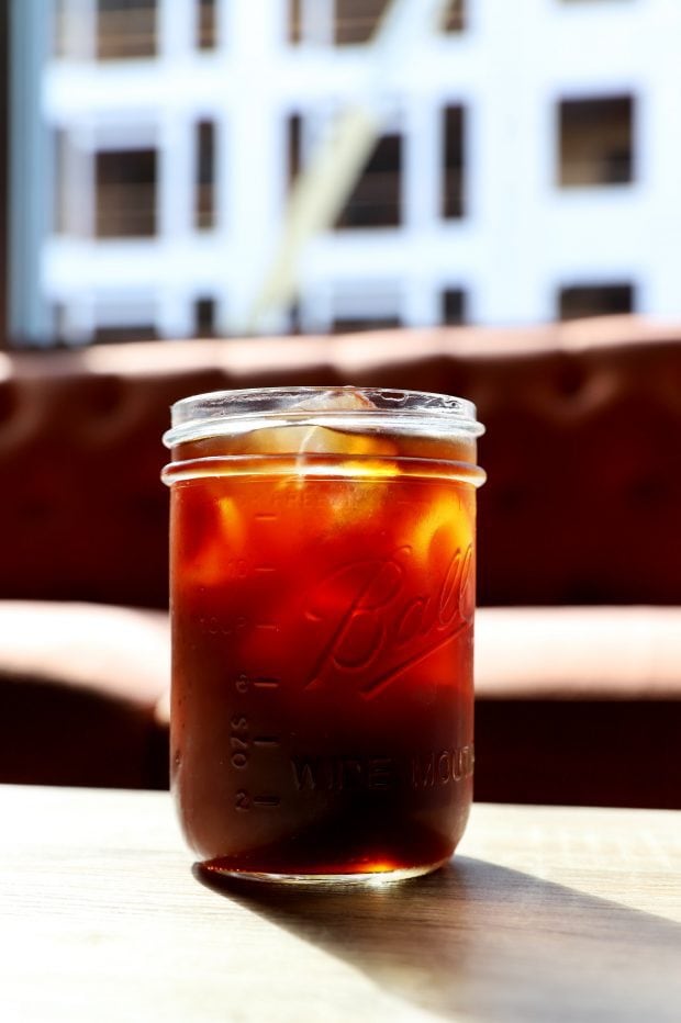 Cold brew coffee in a mason jar glass at a coffee shop for motivation