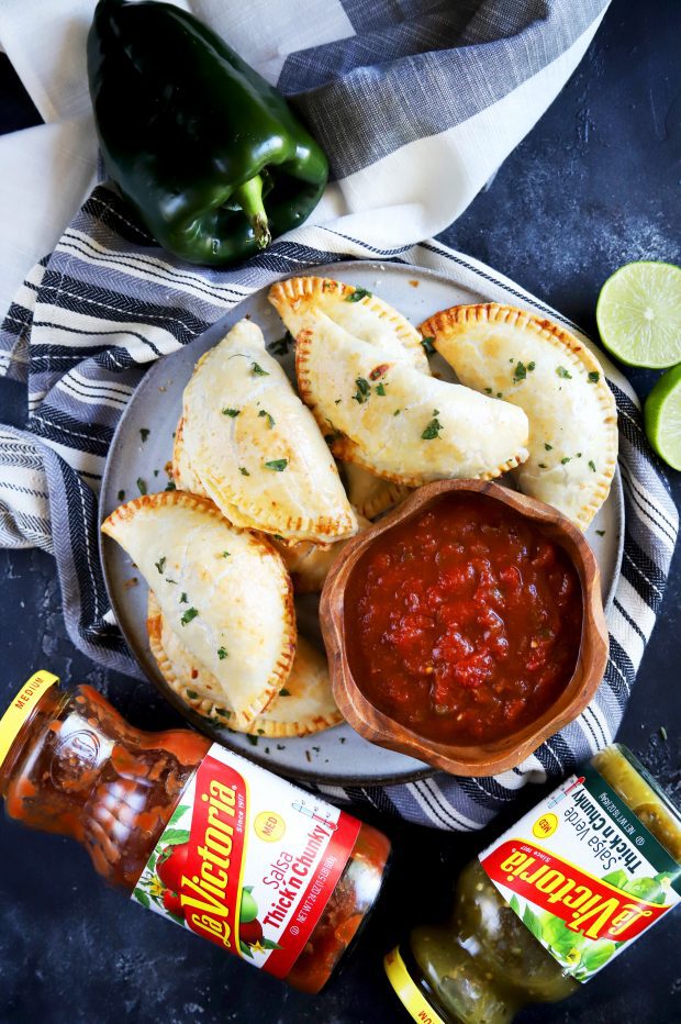 Overhead shot of empanadas with salsa for dipping