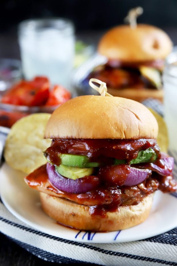 BBQ sandwich with chicken onion and avocado on a plate