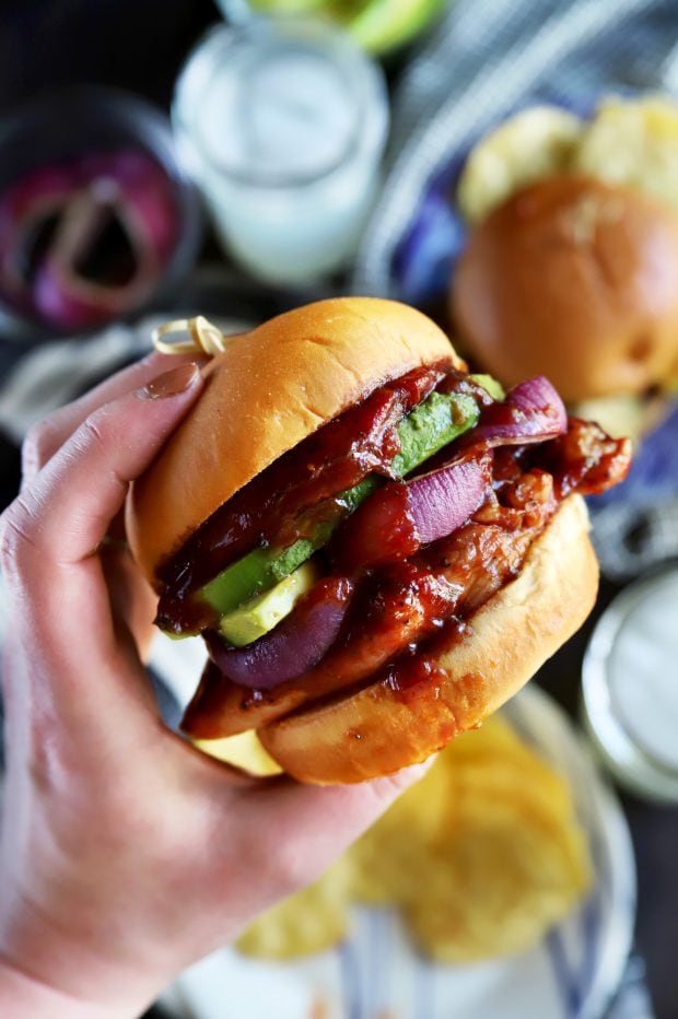 Holding a BBQ sandwich with chicken