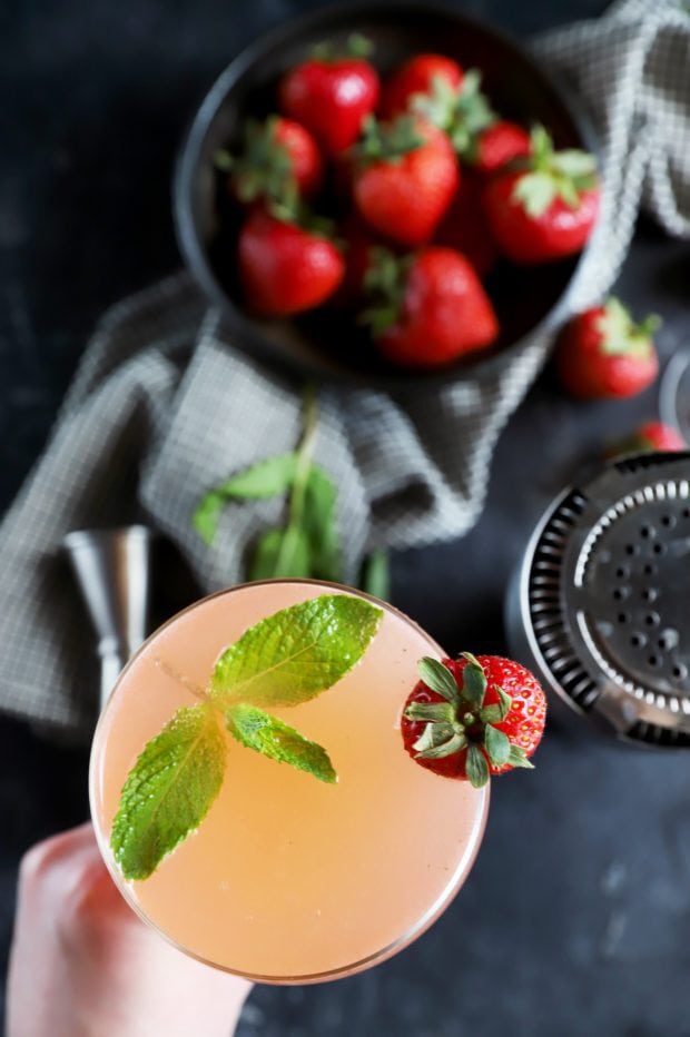 Overhead shot of cocktail being held in a hand