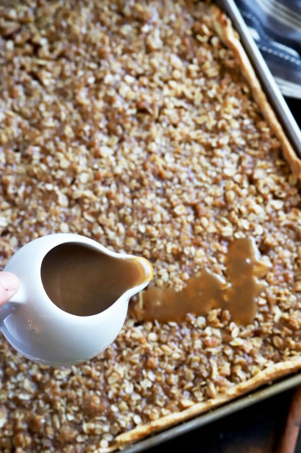 Pouring caramel sauce over slab pie