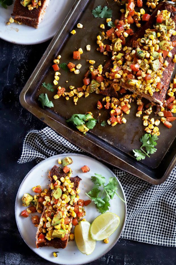 Salmon for dinner on a plate with charred corn salsa