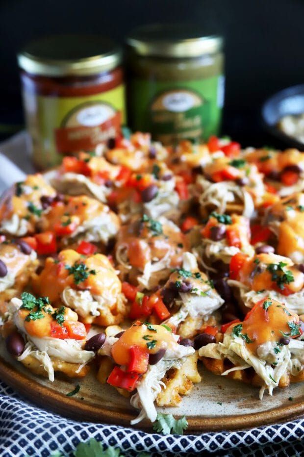 Photograph of bite-sized chicken nachos on a platter