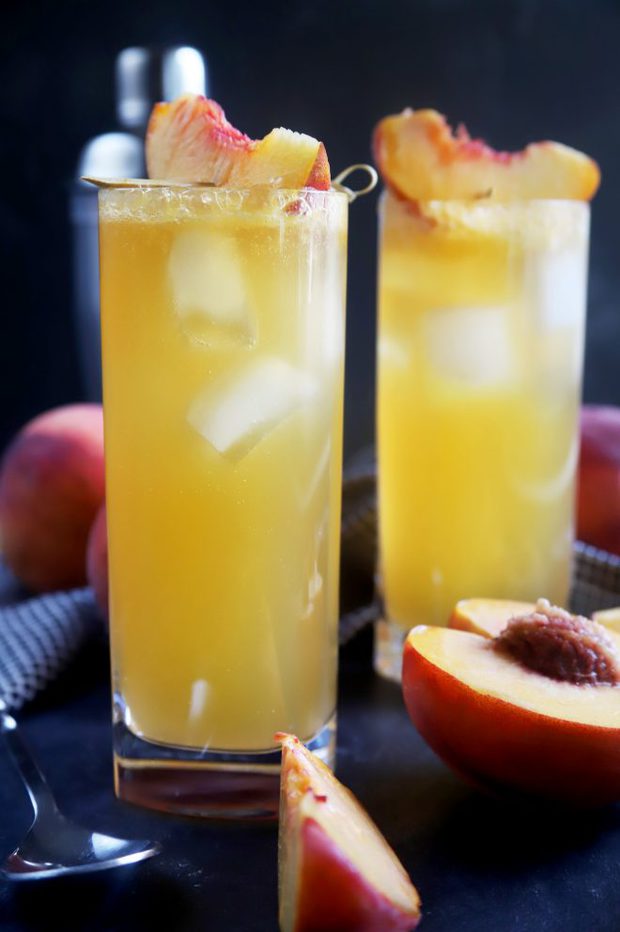 Side shot of two peach highball cocktails