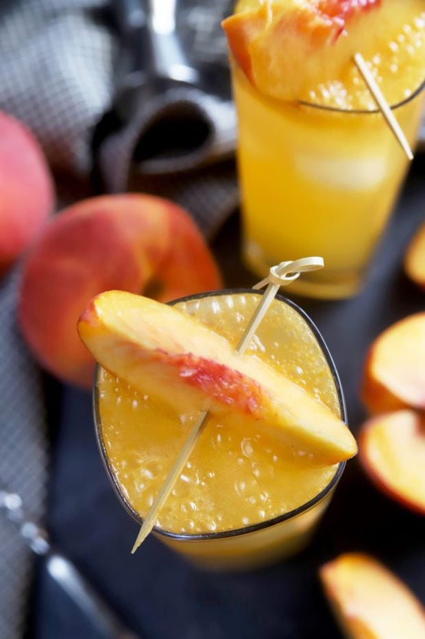 Cocktails garnished with fresh peaches