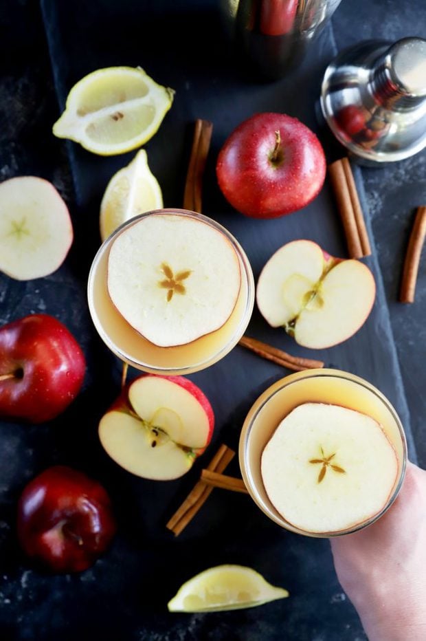 Overhead photo of whiskey apple cocktails with apples