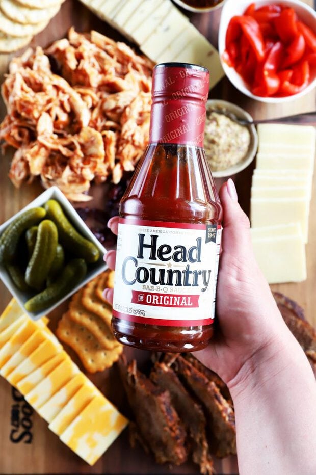 Head Country Bar-B-Q sauce bottle in hand