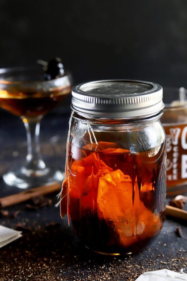 A cocktail, bourbon, and tea in a mug