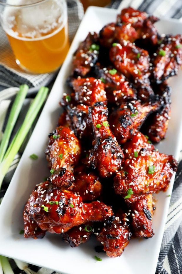 Side shot of snacks on a plate with beer in the background