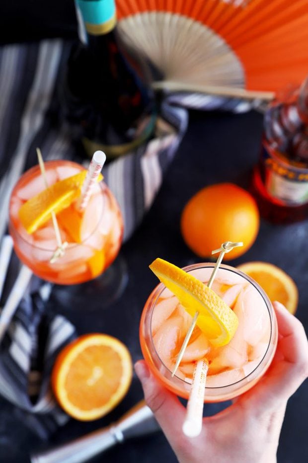 Hand holding a cocktail with a straw