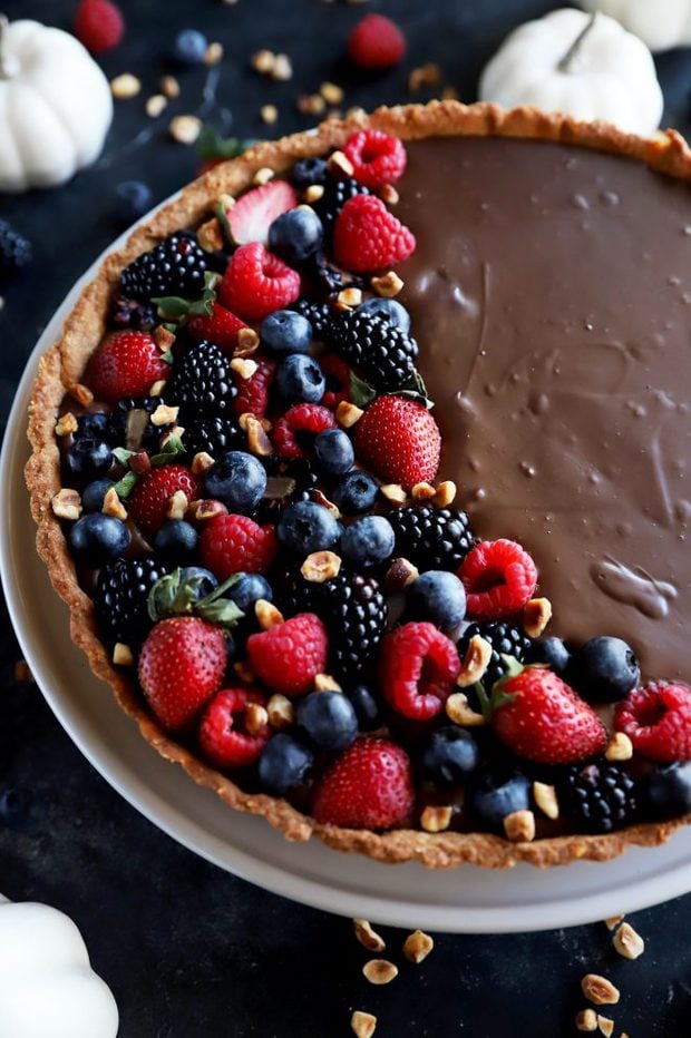 Side view of chocolate tart topped with berries