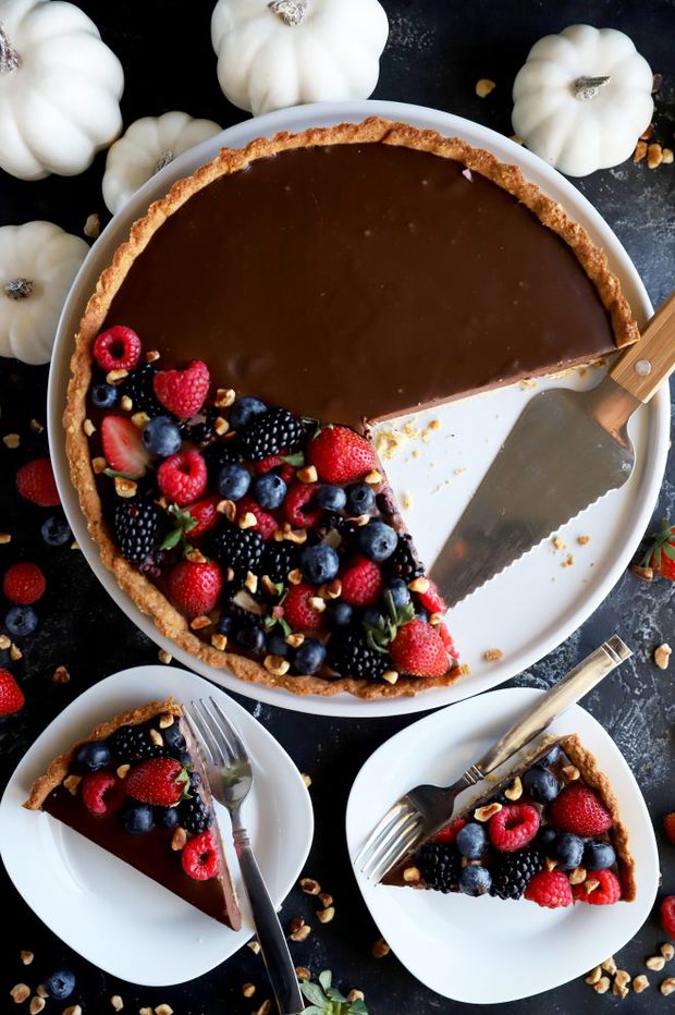 Slices of ganache tart topped with berries