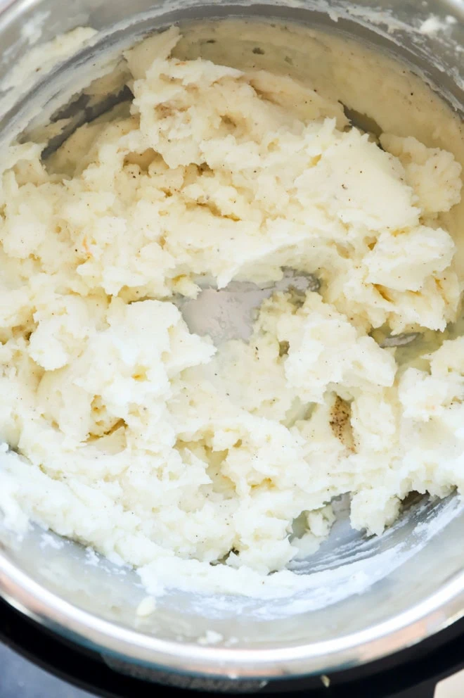 instant pot mashed potatoes mixed together in the insert