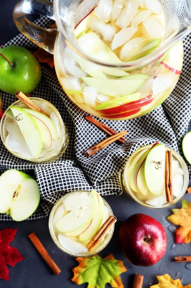 Overhead photo of apple pie sangria in cups and a pitcher