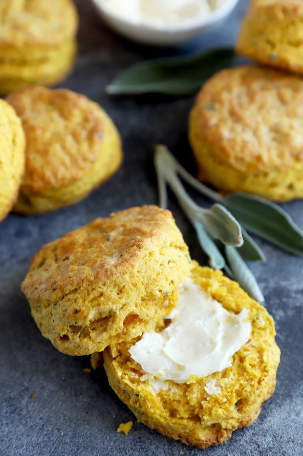 A biscuit cut in half with butter photograph