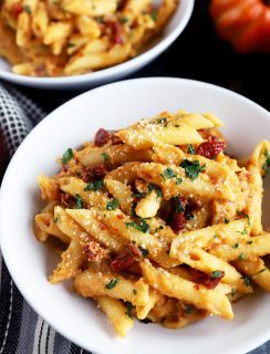 Bowl full of pumpkin pasta with sun-dried tomatoes