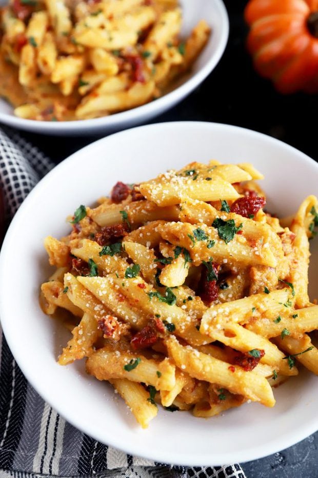 Bowl full of pumpkin pasta with sun-dried tomatoes