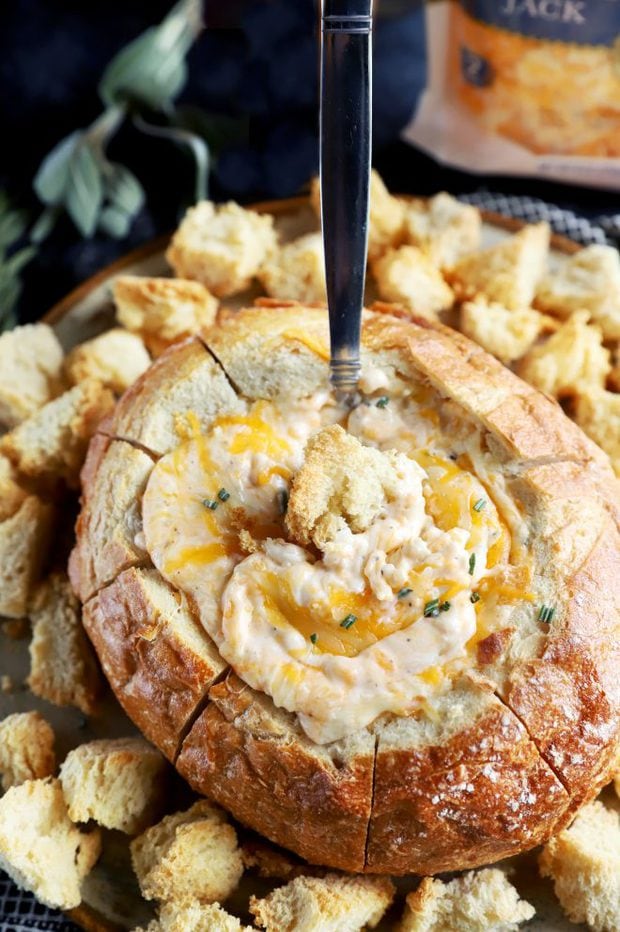 Holiday bread bowl dip with spoon in it