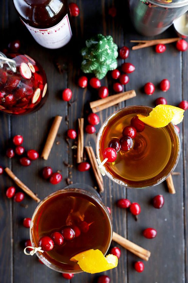 Overhead photo of holiday cocktails with cranberry and cinnamon