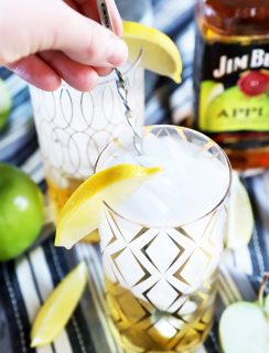 Hand stirring a cocktail in a glass photo