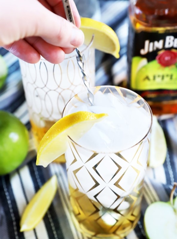 Hand stirring a cocktail in a glass photo