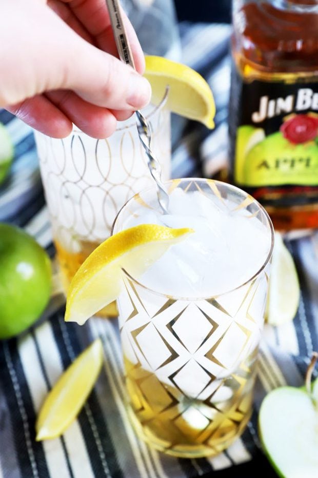 Hand stirring a cocktail in a glass photo