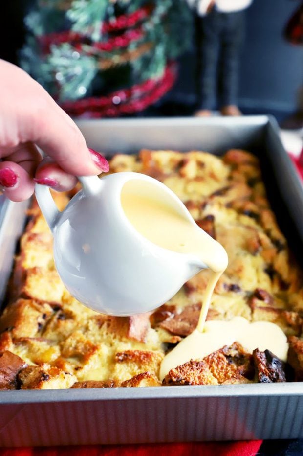 Pouring creme anglaise on top of bread pudding